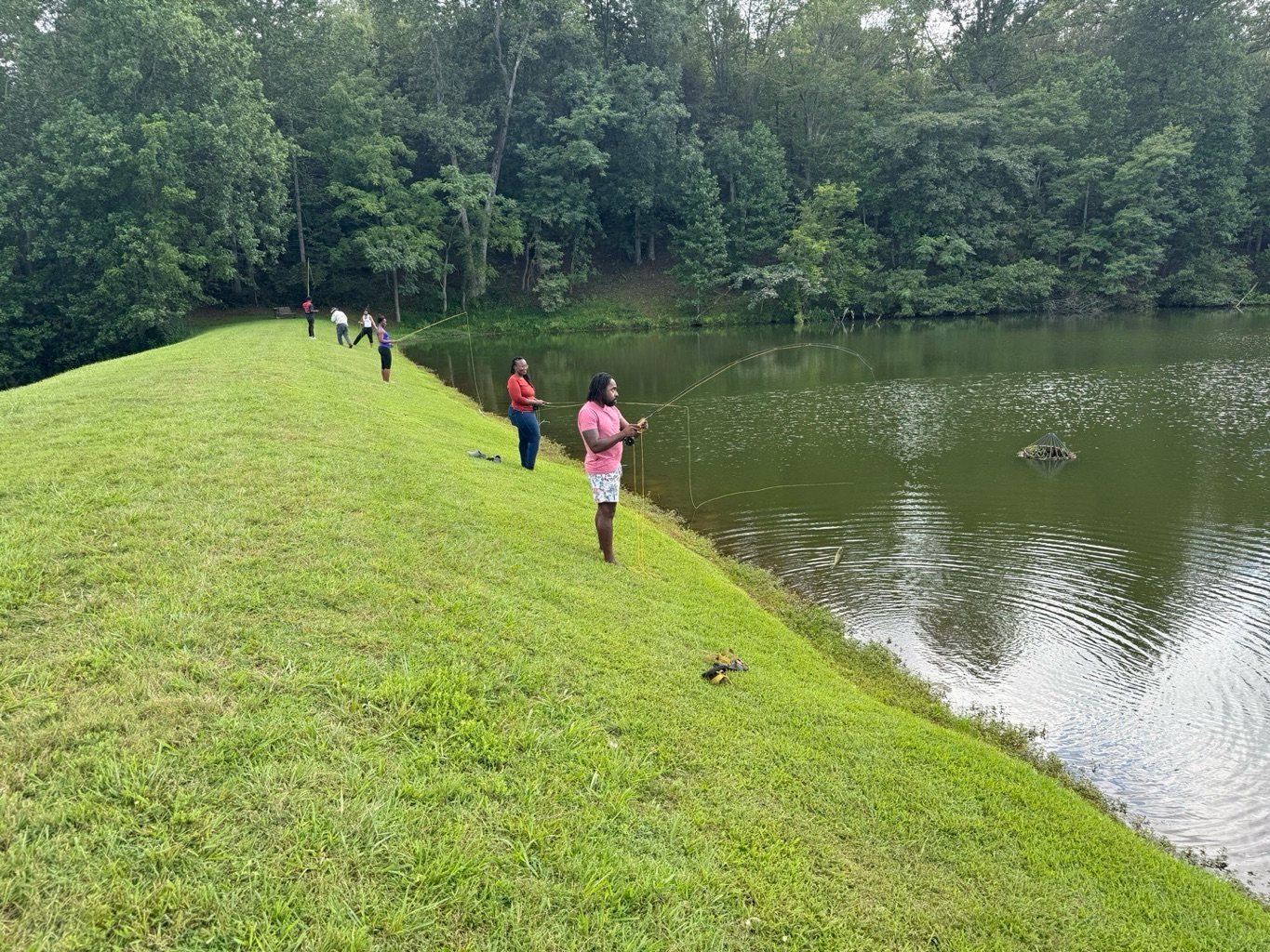 Participants walking the lakeside meadow at Leigheas